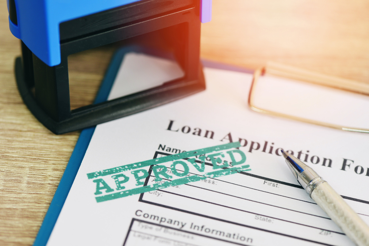 Loan approval, Loan application form with Rubber stamping that says Loan Approved, Financial loan money contract agreement company credit or person.